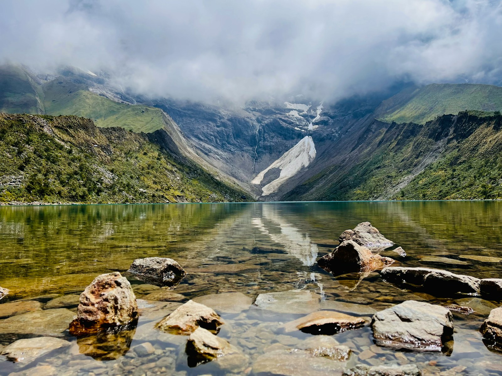 a lake with mountains in the background